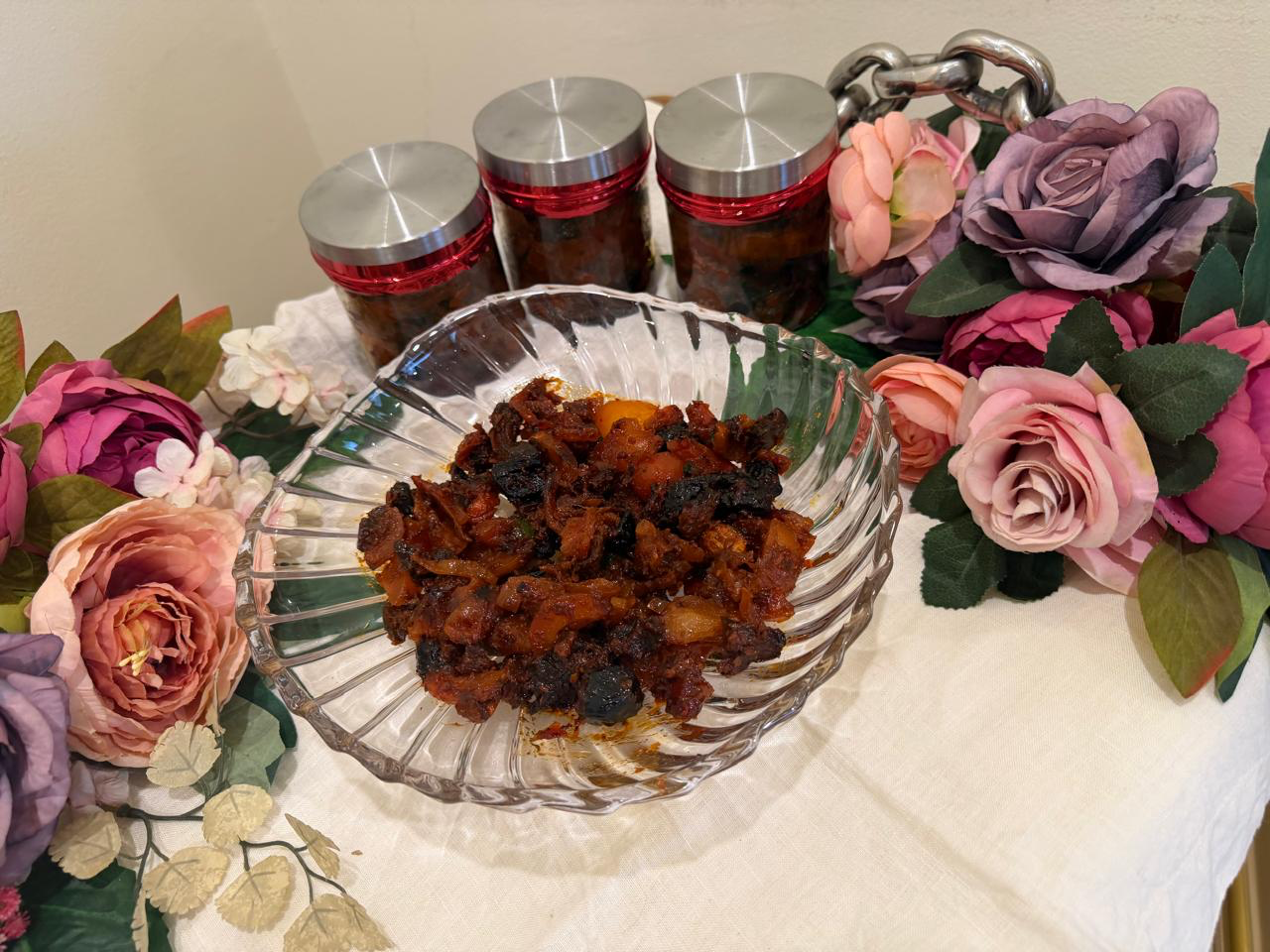 Homemade Malaysian spiced fruit pickle in a glass jar with chilli, carrot and sesame
